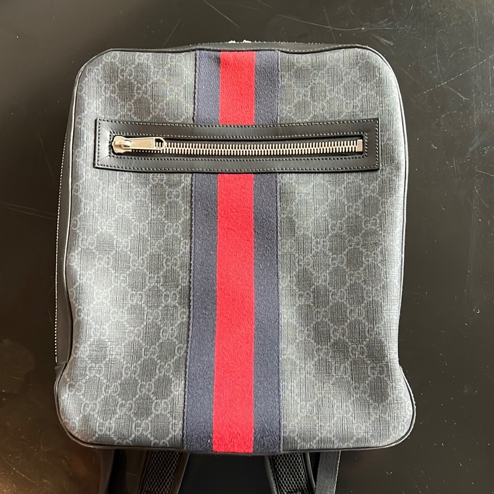 Gucci monogram backpack with signature fabric stripe.